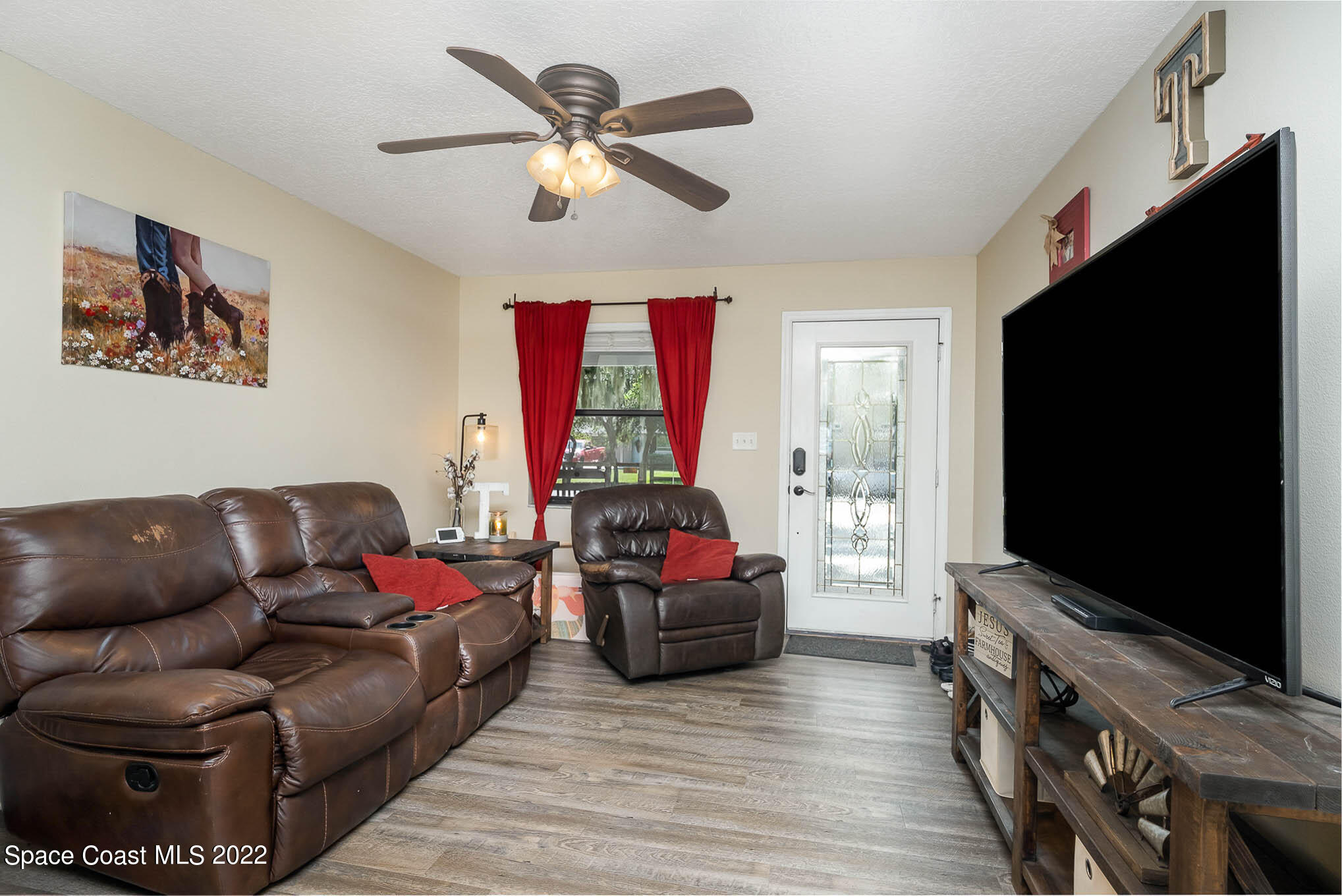 3453 Brevard Road Mims, FL 32754 - Photo 5 of 22 a living room with furniture and a flat screen tv