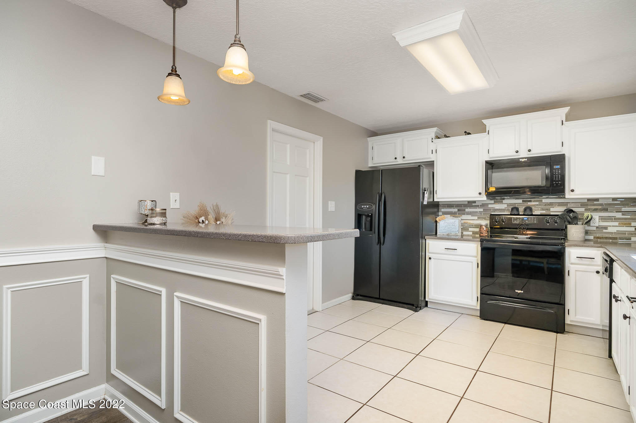 3453 Brevard Road Mims, FL 32754 - Photo 8 of 22 a kitchen with a sink a stove and refrigerator