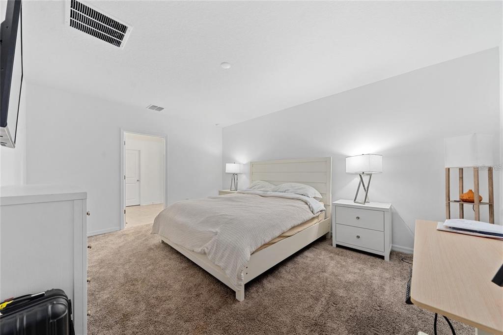 3977 Willowbrook Drive Edgewater, FL 32141 - Photo 12 of 22 a bedroom with a bed and a cabinets