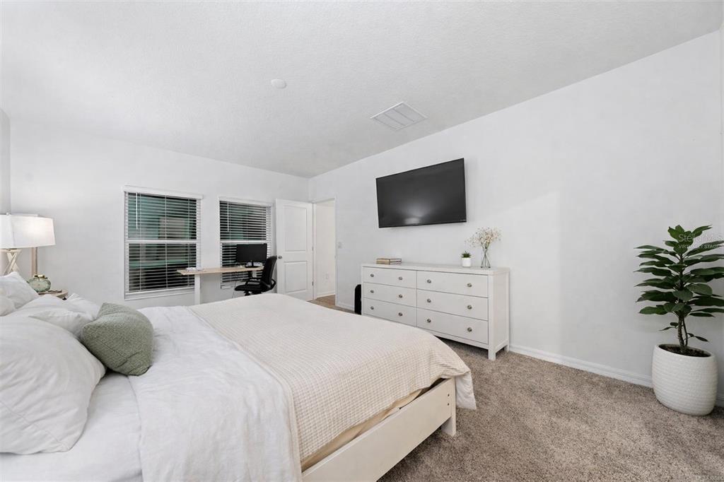 3977 Willowbrook Drive Edgewater, FL 32141 - Photo 13 of 22 a bedroom with a bed and a flat screen tv