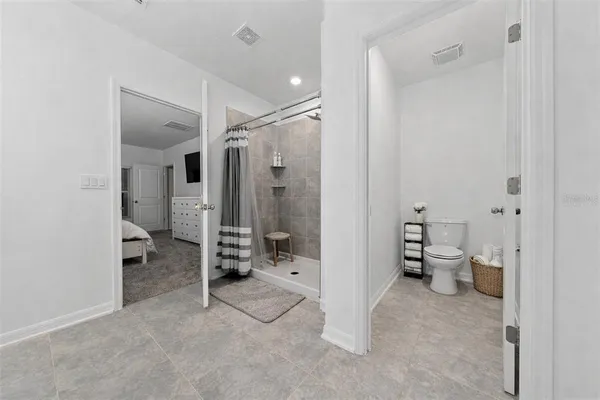 a spacious bathroom with double vanity sinks and a mirror