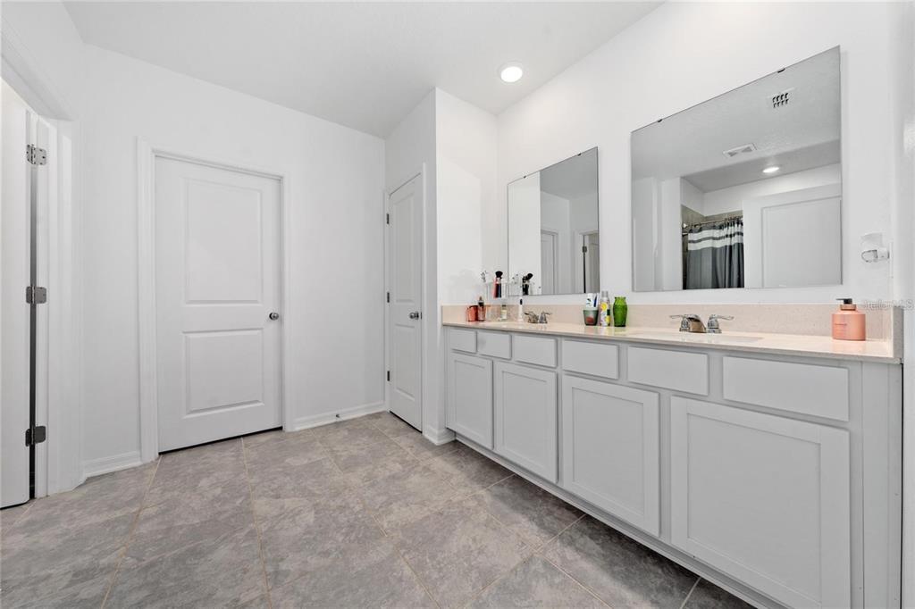 3977 Willowbrook Drive Edgewater, FL 32141 - Photo 16 of 22 a spacious bathroom with double vanity sinks and a mirror