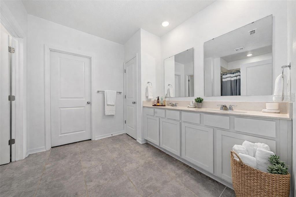3977 Willowbrook Drive Edgewater, FL 32141 - Photo 17 of 22 a spacious bathroom with a double vanity sink and mirror