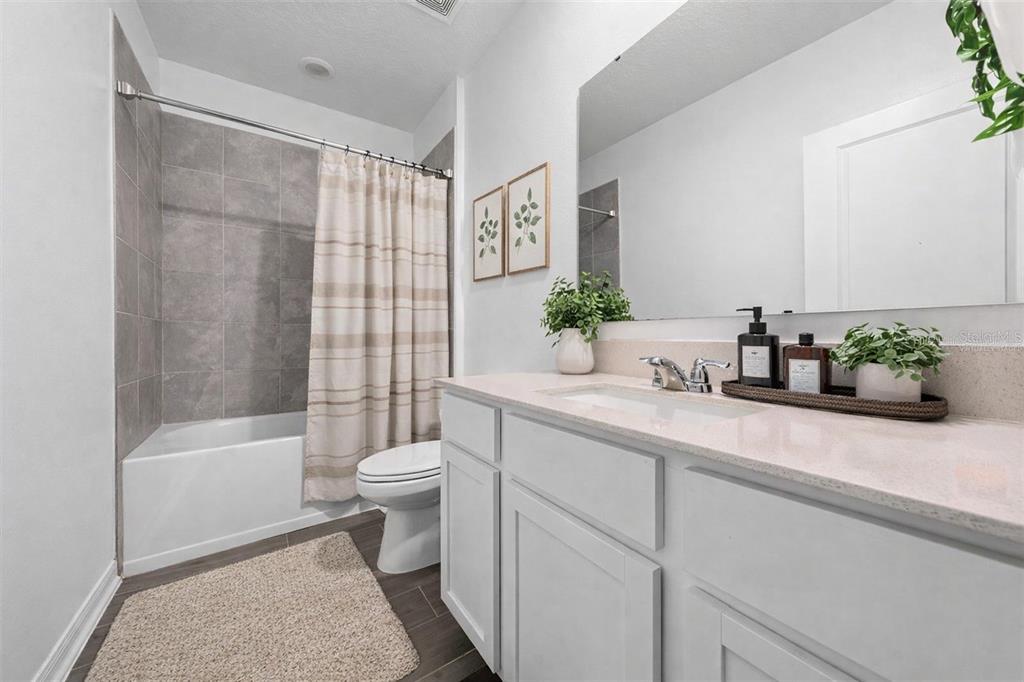 3977 Willowbrook Drive Edgewater, FL 32141 - Photo 20 of 22 a bathroom with a sink a toilet a tub and shower