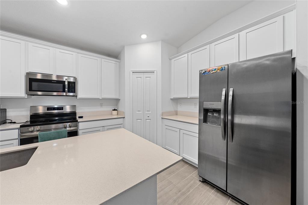 3977 Willowbrook Drive Edgewater, FL 32141 - Photo 2 of 22 a kitchen with stainless steel appliances and refrigerator