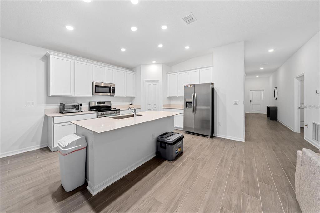 3977 Willowbrook Drive Edgewater, FL 32141 - Photo 3 of 22 a kitchen with stainless steel appliances a refrigerator sink and microwave