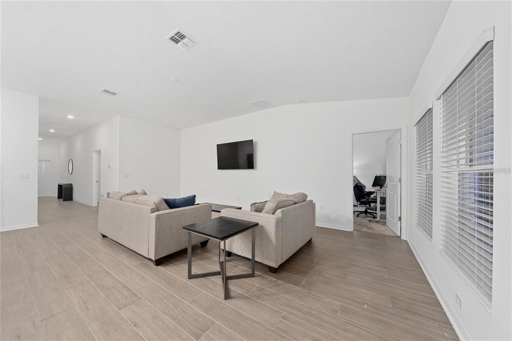 3977 Willowbrook Drive Edgewater, FL 32141 - Photo 6 of 22 a living room with furniture and a wooden floor