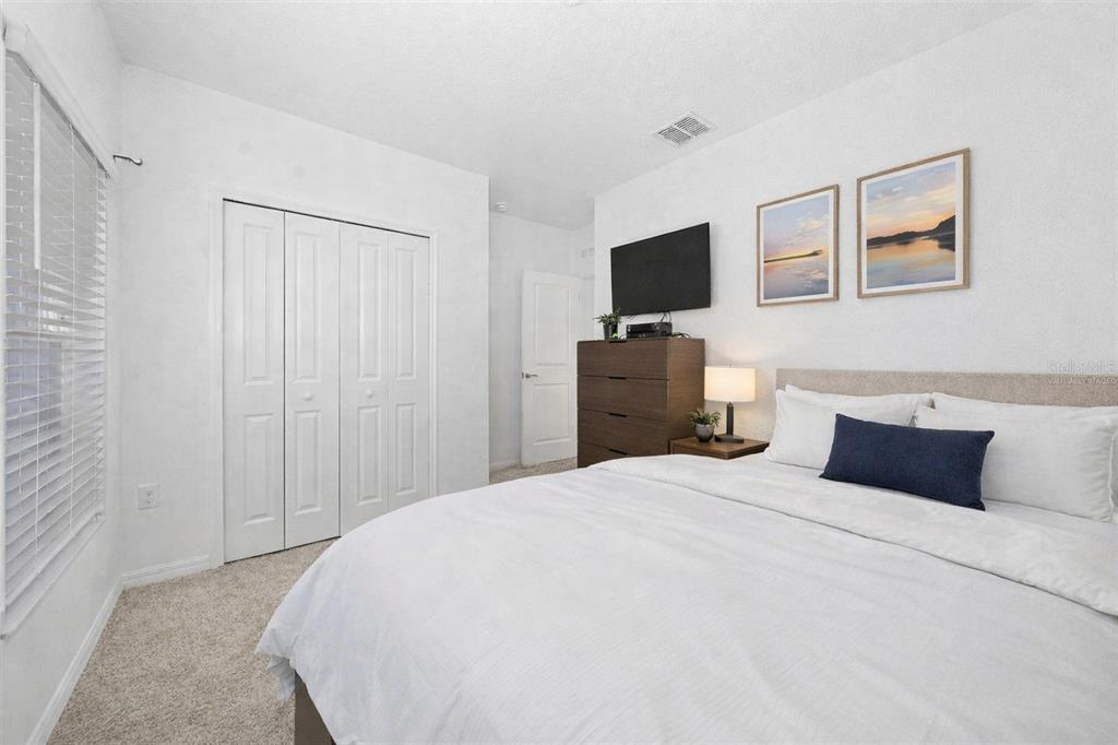 3977 Willowbrook Drive Edgewater, FL 32141 - Photo 8 of 22 a bedroom with a bed and a flat screen tv