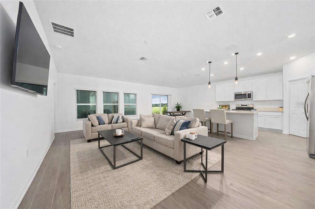 3977 Willowbrook Drive Edgewater, FL 32141 - Photo 10 of 22 a living room with furniture and a flat screen tv