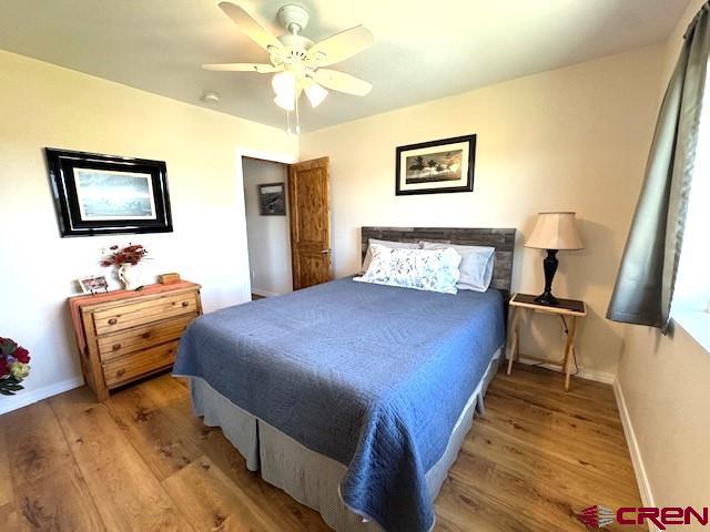 10377 Road 23.5 Cortez, CO 81321 - Photo 17 of 45 a bedroom with a bed and a chandelier