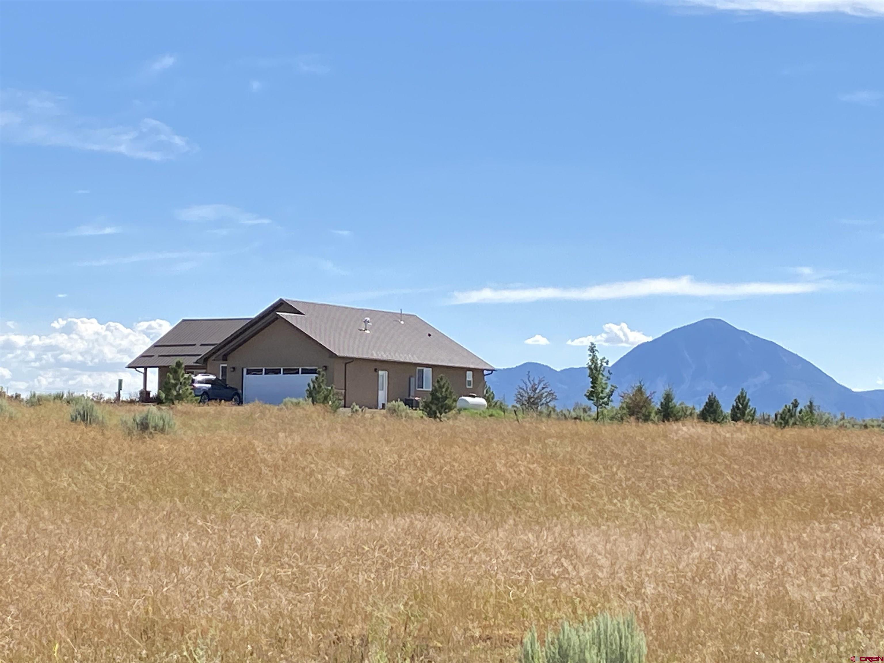 10377 Road 23.5 Cortez, CO 81321 - Photo 21 of 45 a front view of a house with a yard