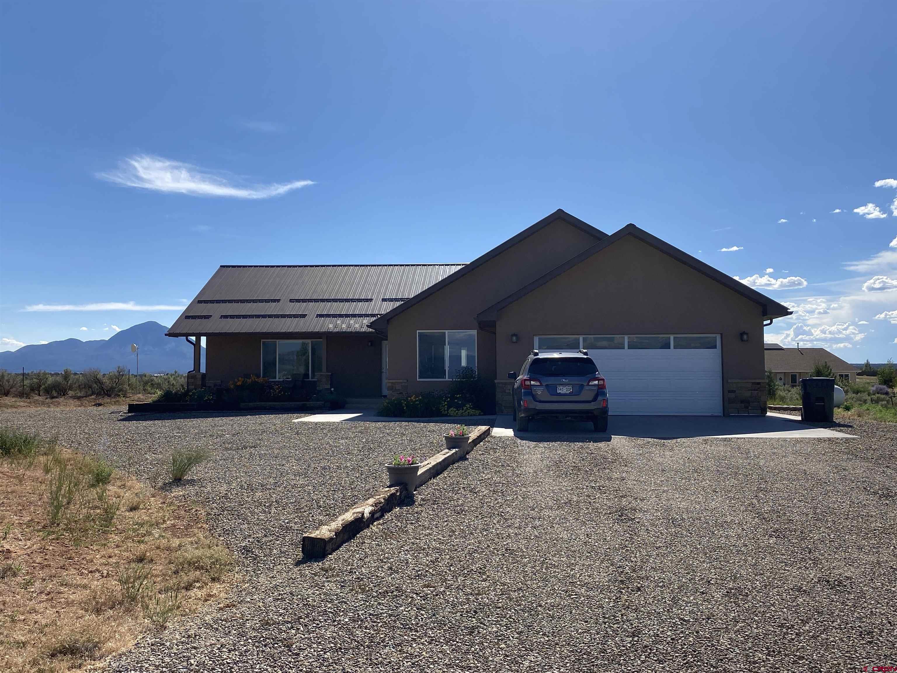 10377 Road 23.5 Cortez, CO 81321 - Photo 43 of 45 a front view of a house with a yard