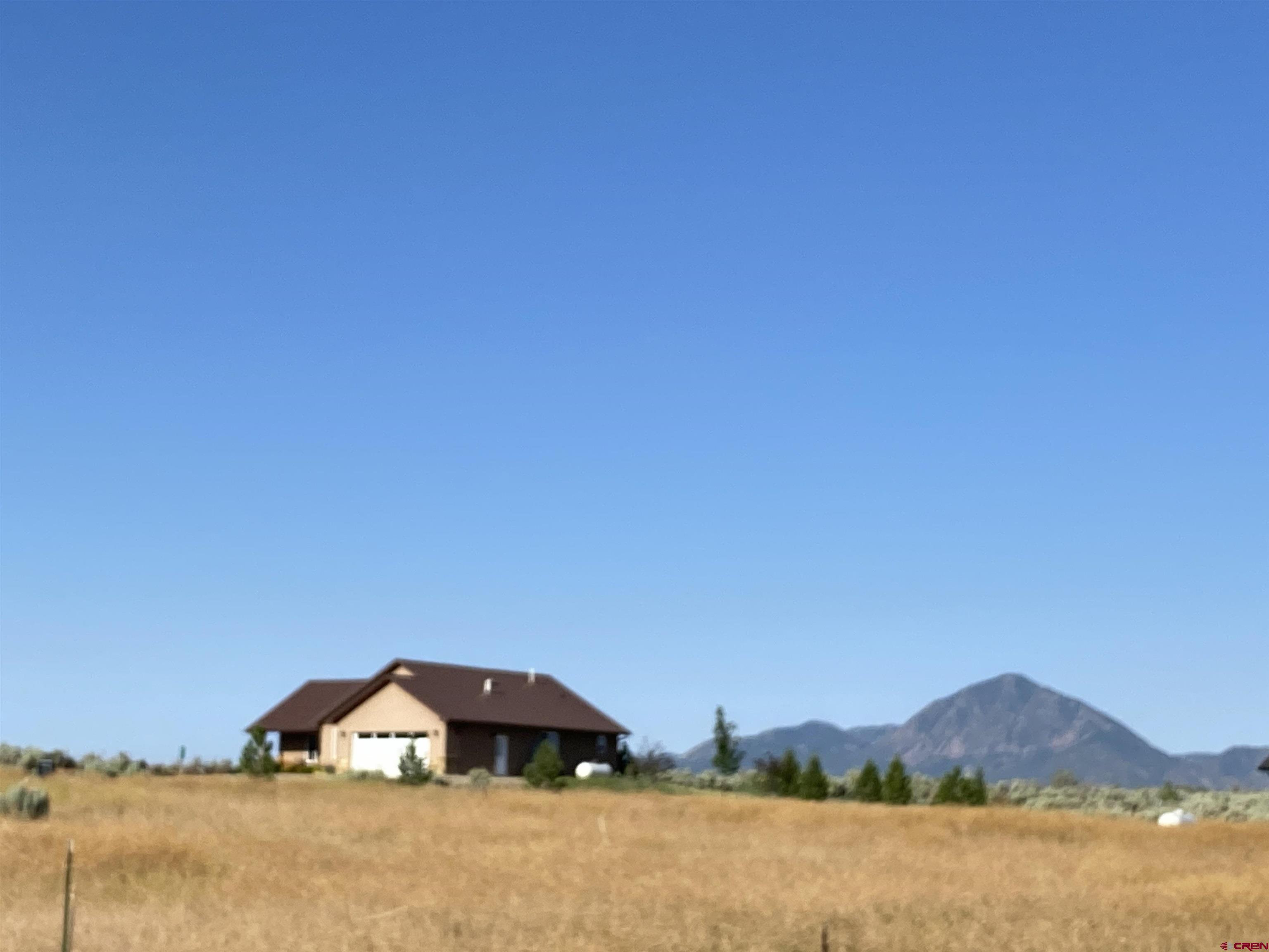 10377 Road 23.5 Cortez, CO 81321 - Photo 45 of 45 a view of a house with a yard and a mountain view