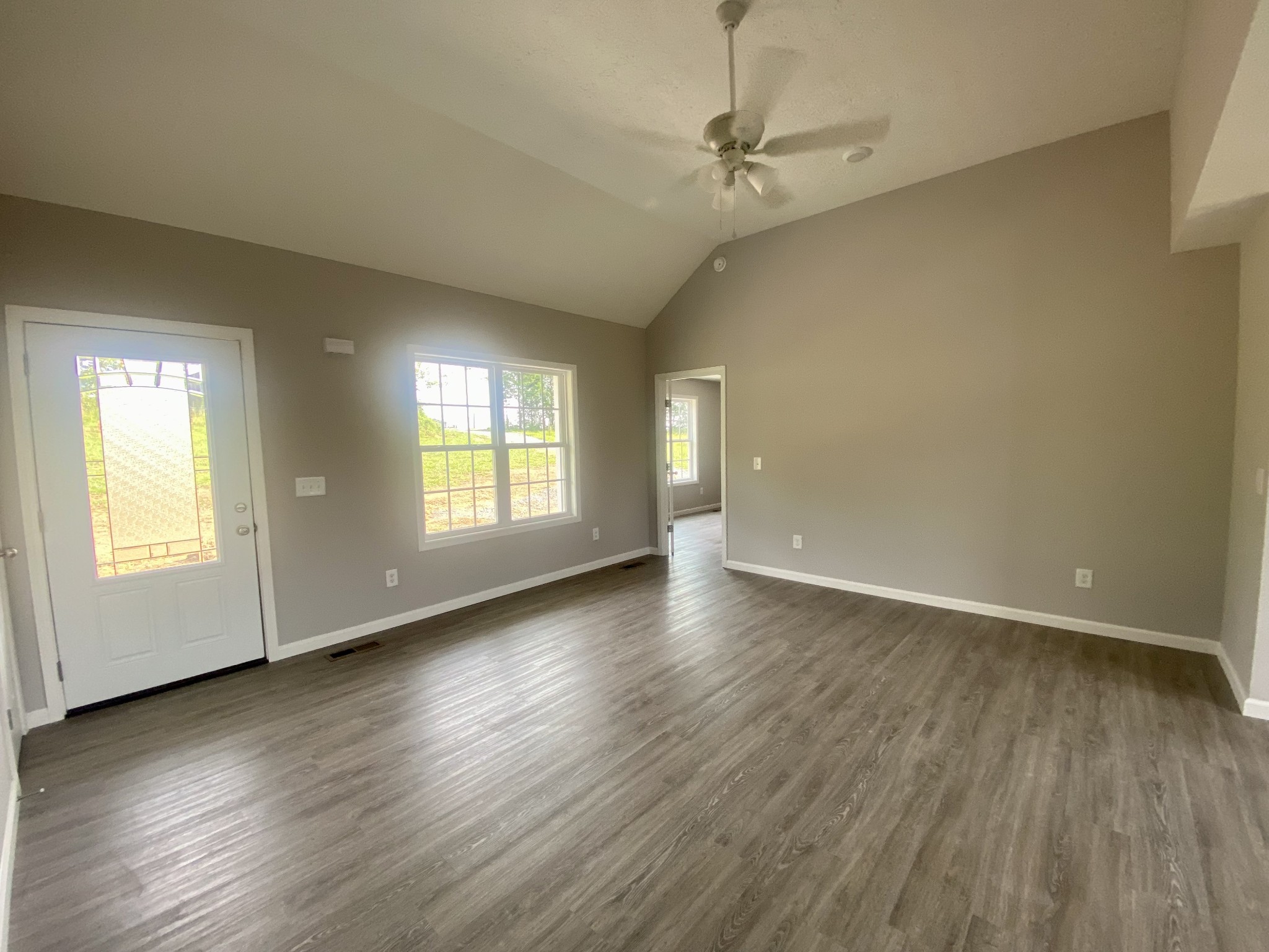380 Calvert Ridge Road Westmoreland, TN 37186 - Photo 6 of 18 an empty room with wooden floor and windows
