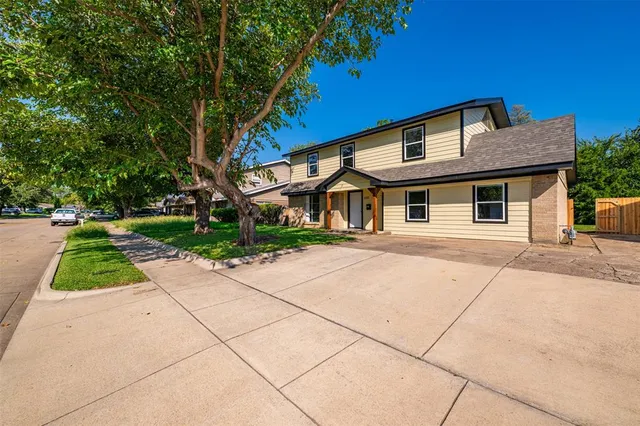 a front view of house with a garden
