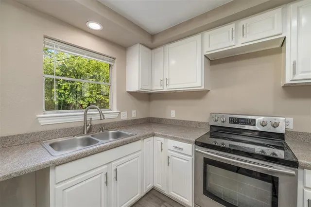a kitchen with a sink stove and cabinets