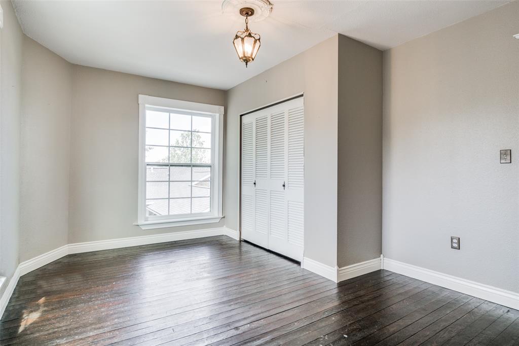 1211 Cherokee Street Weatherford, TX 76086 - Photo 14 of 29 an empty room with wooden floor chandelier and windows