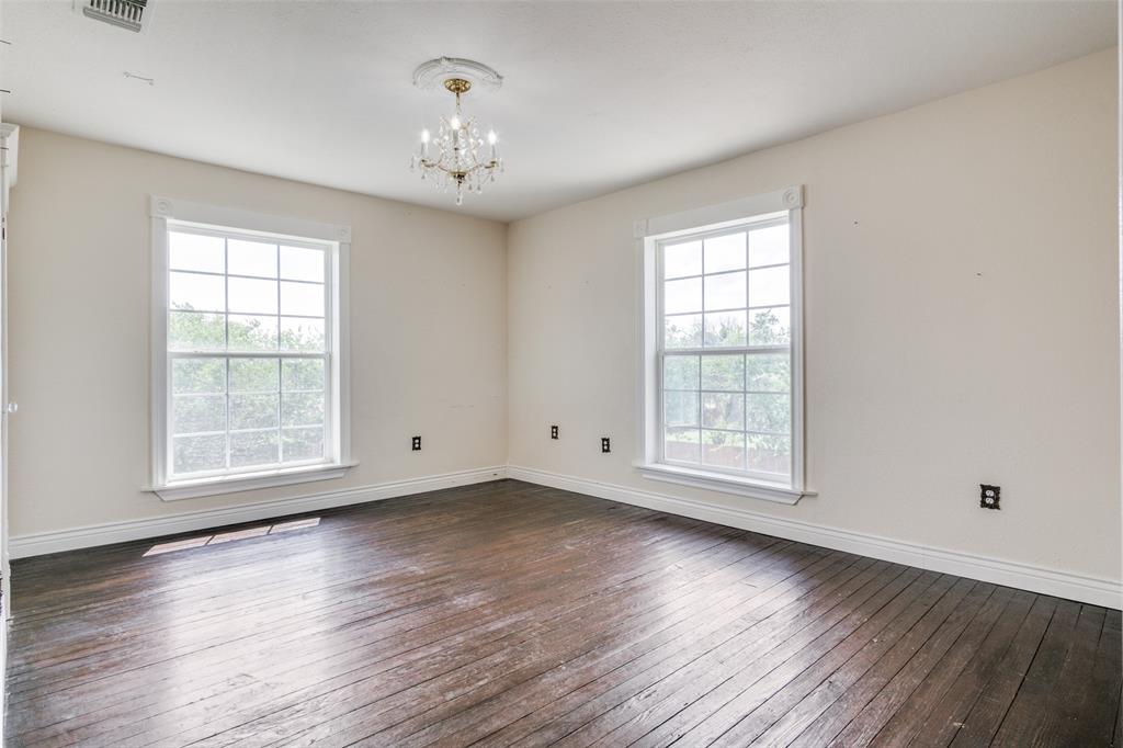 1211 Cherokee Street Weatherford, TX 76086 - Photo 15 of 29 a view of an empty room with wooden floor and a window