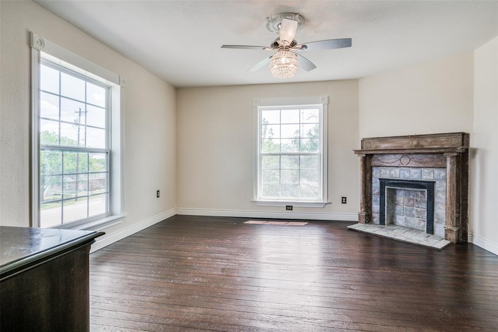 1211 Cherokee Street Weatherford, TX 76086 - Photo 16 of 29 an empty room with wooden floor fireplace and windows