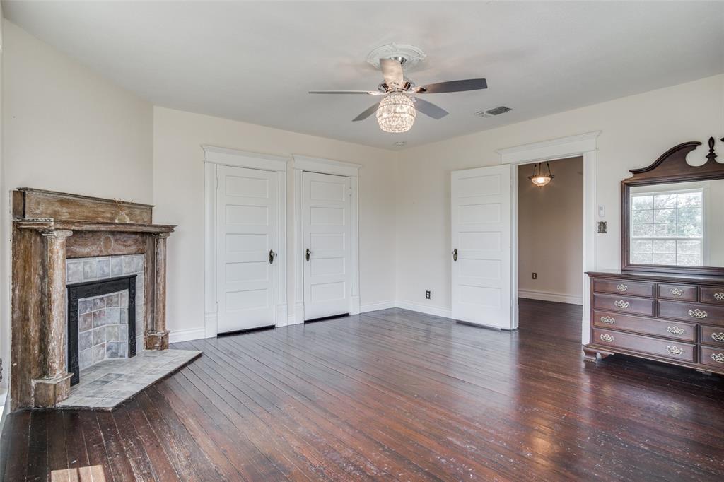 1211 Cherokee Street Weatherford, TX 76086 - Photo 17 of 29 a view of an empty room with wooden floor and a window