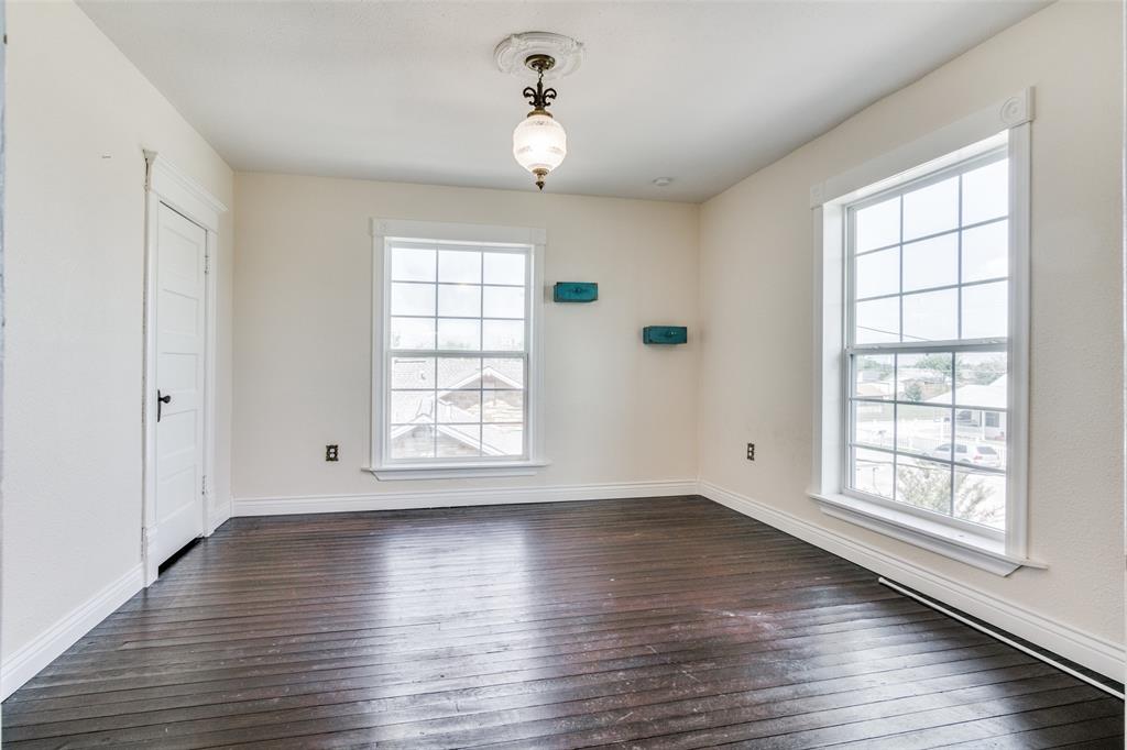 1211 Cherokee Street Weatherford, TX 76086 - Photo 18 of 29 an empty room with wooden floor and windows