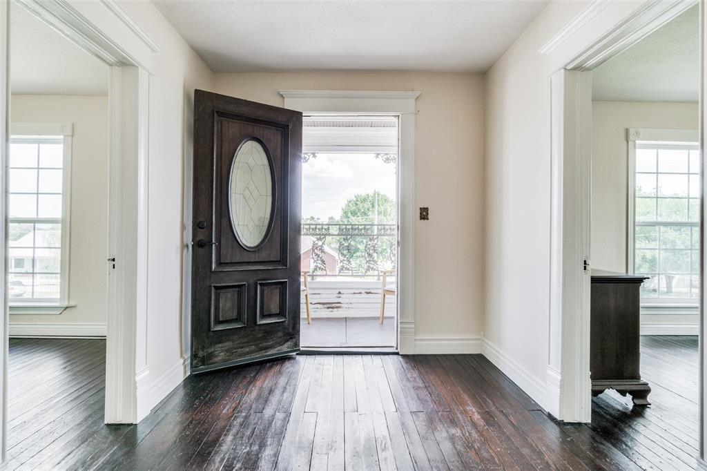 1211 Cherokee Street Weatherford, TX 76086 - Photo 19 of 29 an empty room with wooden floor mirror and windows