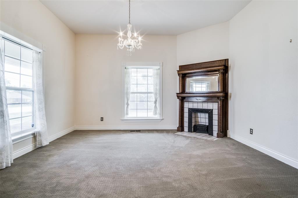 1211 Cherokee Street Weatherford, TX 76086 - Photo 7 of 29 an empty room with windows and fireplace