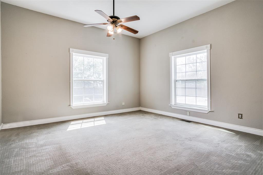 1211 Cherokee Street Weatherford, TX 76086 - Photo 8 of 29 an empty room with windows and fan