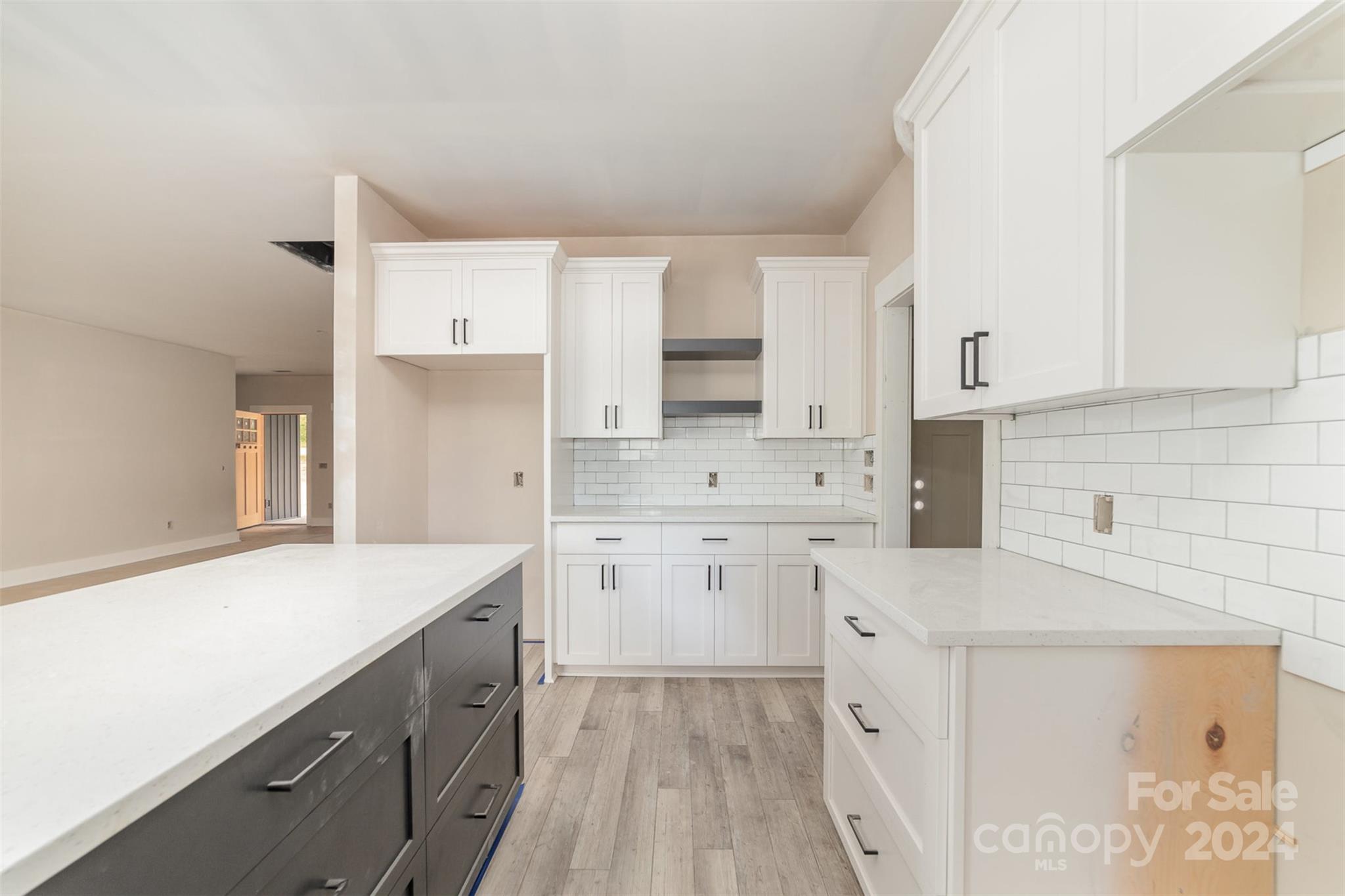 1820 Red Angus Road Mount Pleasant, NC 28124 - Photo 12 of 24 a kitchen with granite countertop white cabinets and white appliances