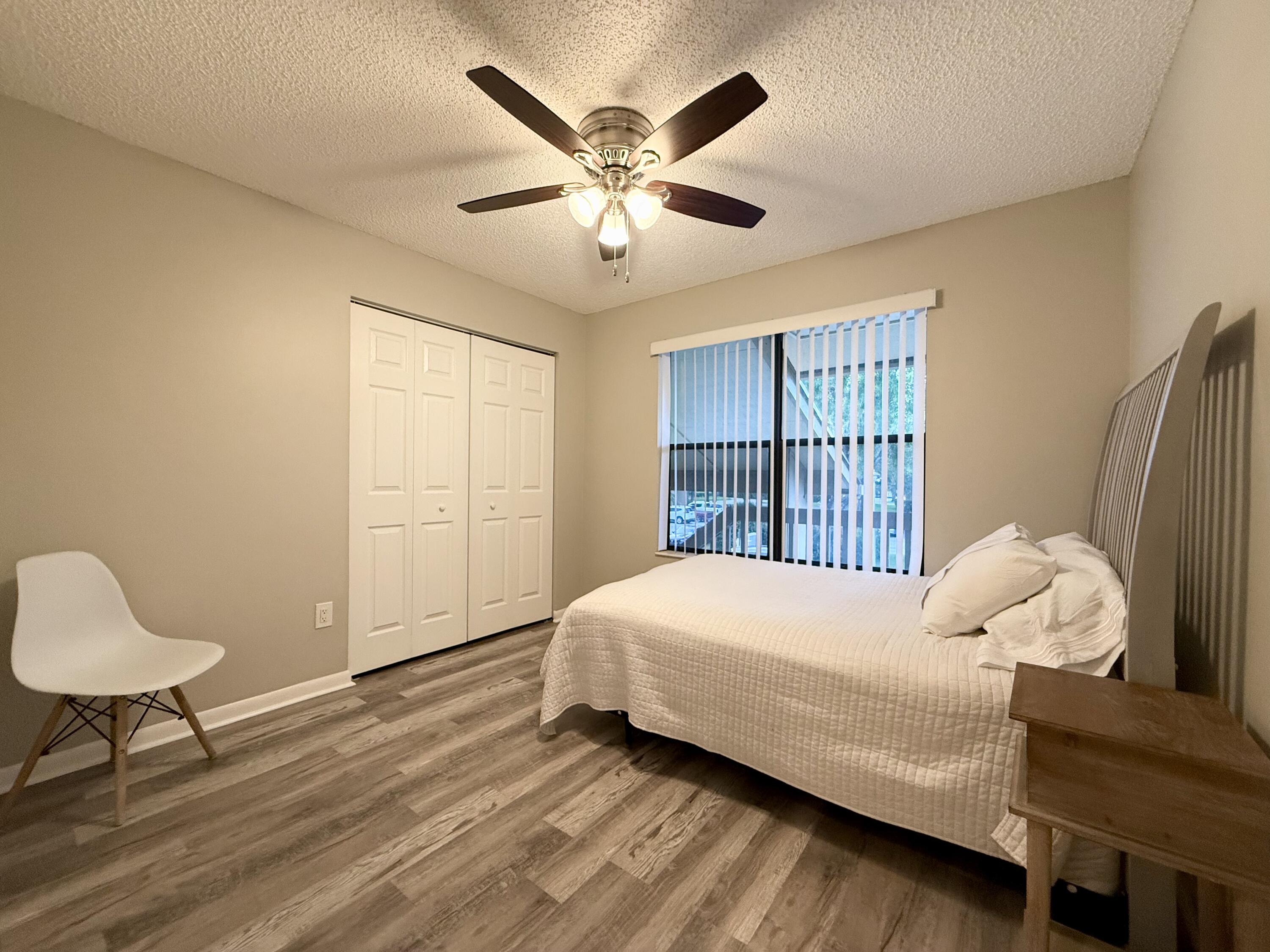 12969 Pennypacker Trail, Unit 15 Wellington, FL 33414 - Photo 12 of 25 a bedroom with a bed and a window