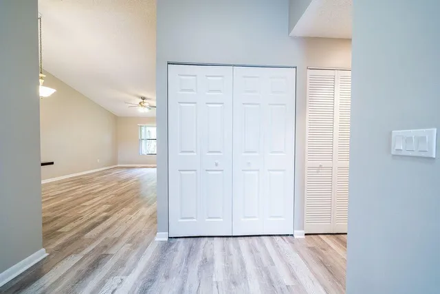 a view of empty room with wooden floor