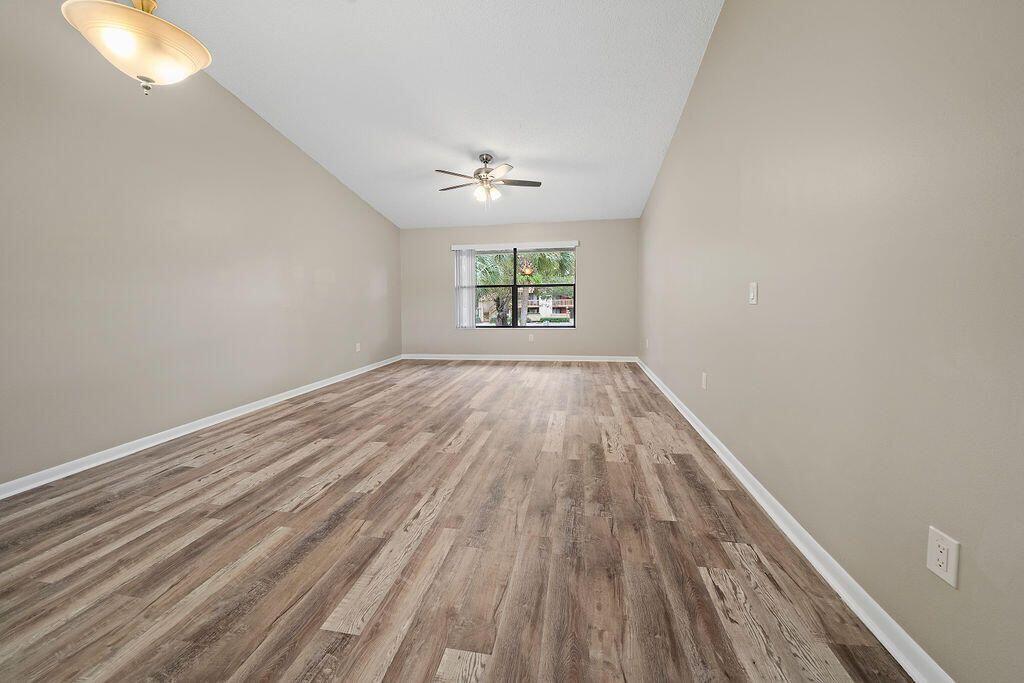 12969 Pennypacker Trail, Unit 15 Wellington, FL 33414 - Photo 16 of 25 wooden floor in an empty room with a window