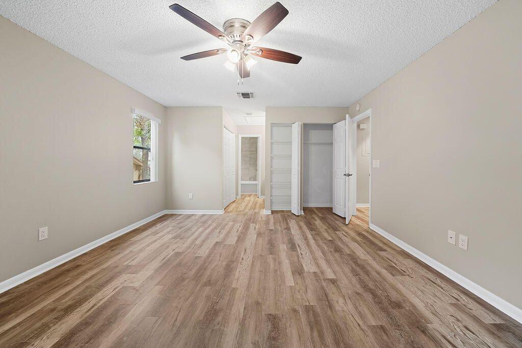 12969 Pennypacker Trail, Unit 15 Wellington, FL 33414 - Photo 18 of 25 wooden floor in an empty room with a window