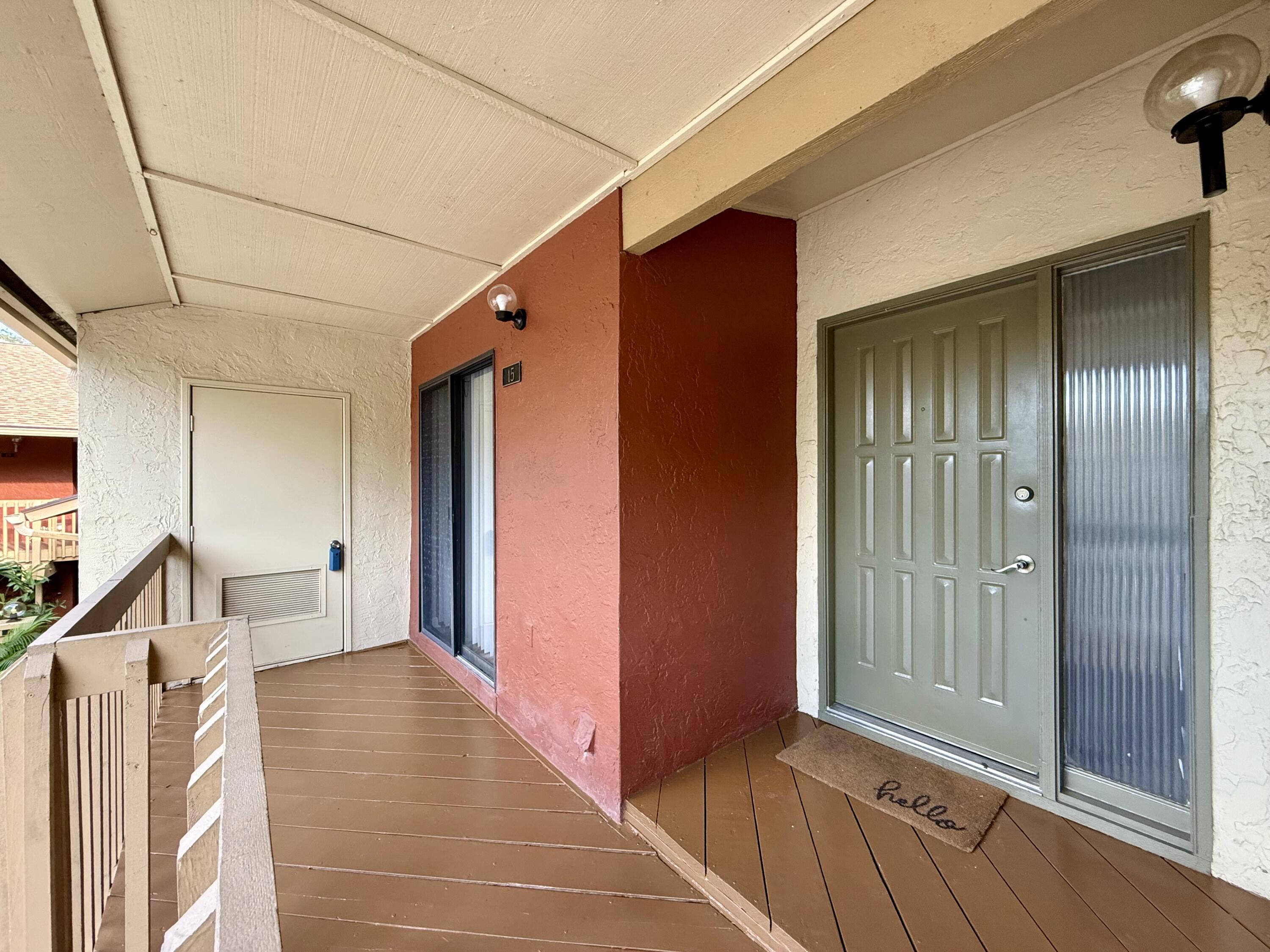 12969 Pennypacker Trail, Unit 15 Wellington, FL 33414 - Photo 21 of 25 a view of a hallway with wooden floor and staircase