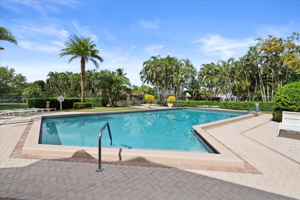 12969 Pennypacker Trail, Unit 15 Wellington, FL 33414 - Photo 24 of 25 a view of a yard with a table and chair