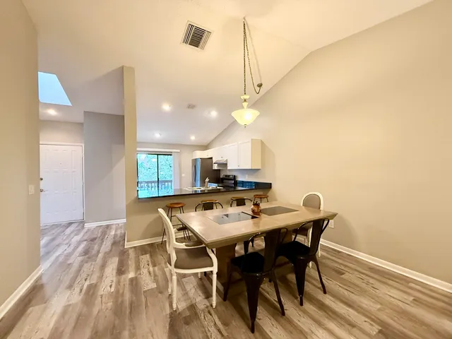 a view of a dining room with furniture and wooden floor