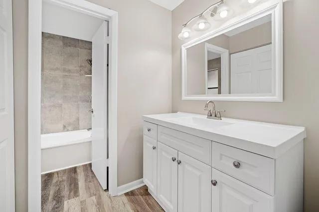 a bathroom with a sink vanity and a mirror