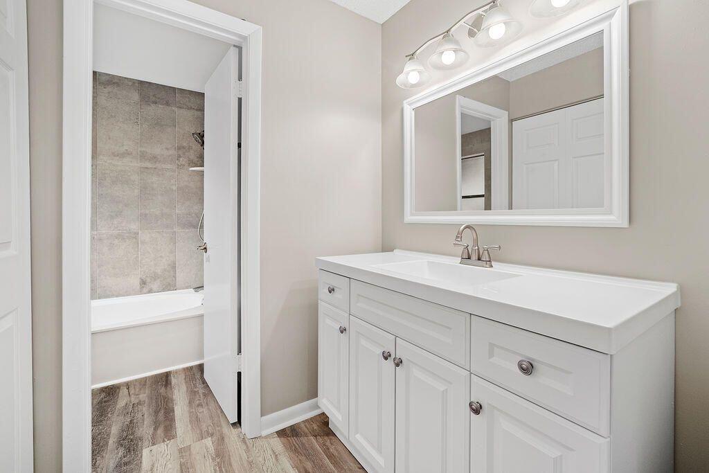 12969 Pennypacker Trail, Unit 15 Wellington, FL 33414 - Photo 6 of 25 a bathroom with a sink vanity and a mirror