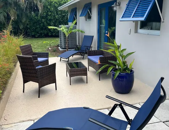 a view of a backyard with furniture and a garden