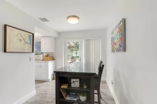 a view of a dining room with furniture and window