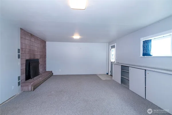an empty room with fireplace