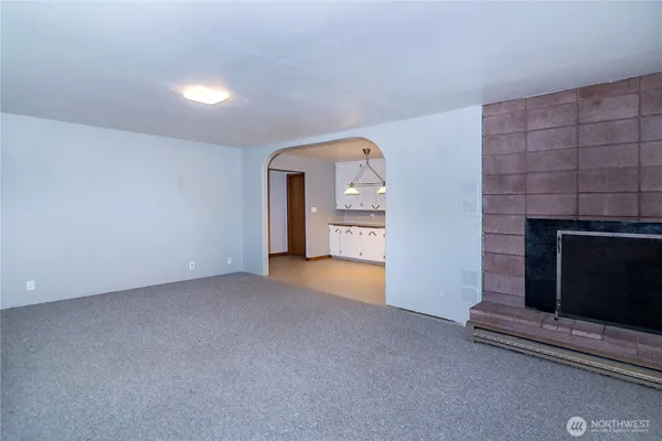 a view of empty room with a fireplace