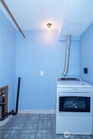 a view of room with wooden floor and furniture