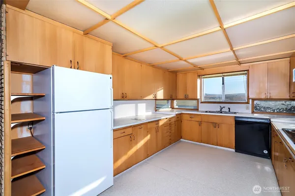 a kitchen with a refrigerator and a sink