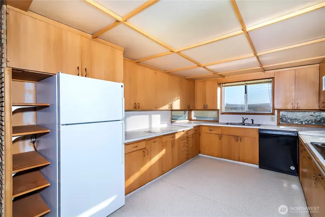 a kitchen with a refrigerator and a sink