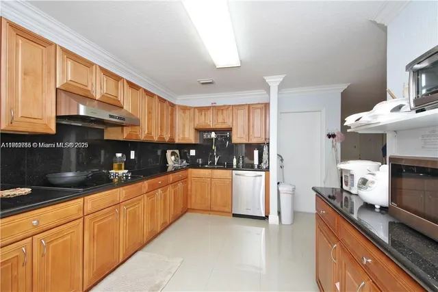 a kitchen with granite countertop white cabinets and white appliances