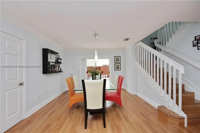 a view of a dining room with furniture and wooden floor