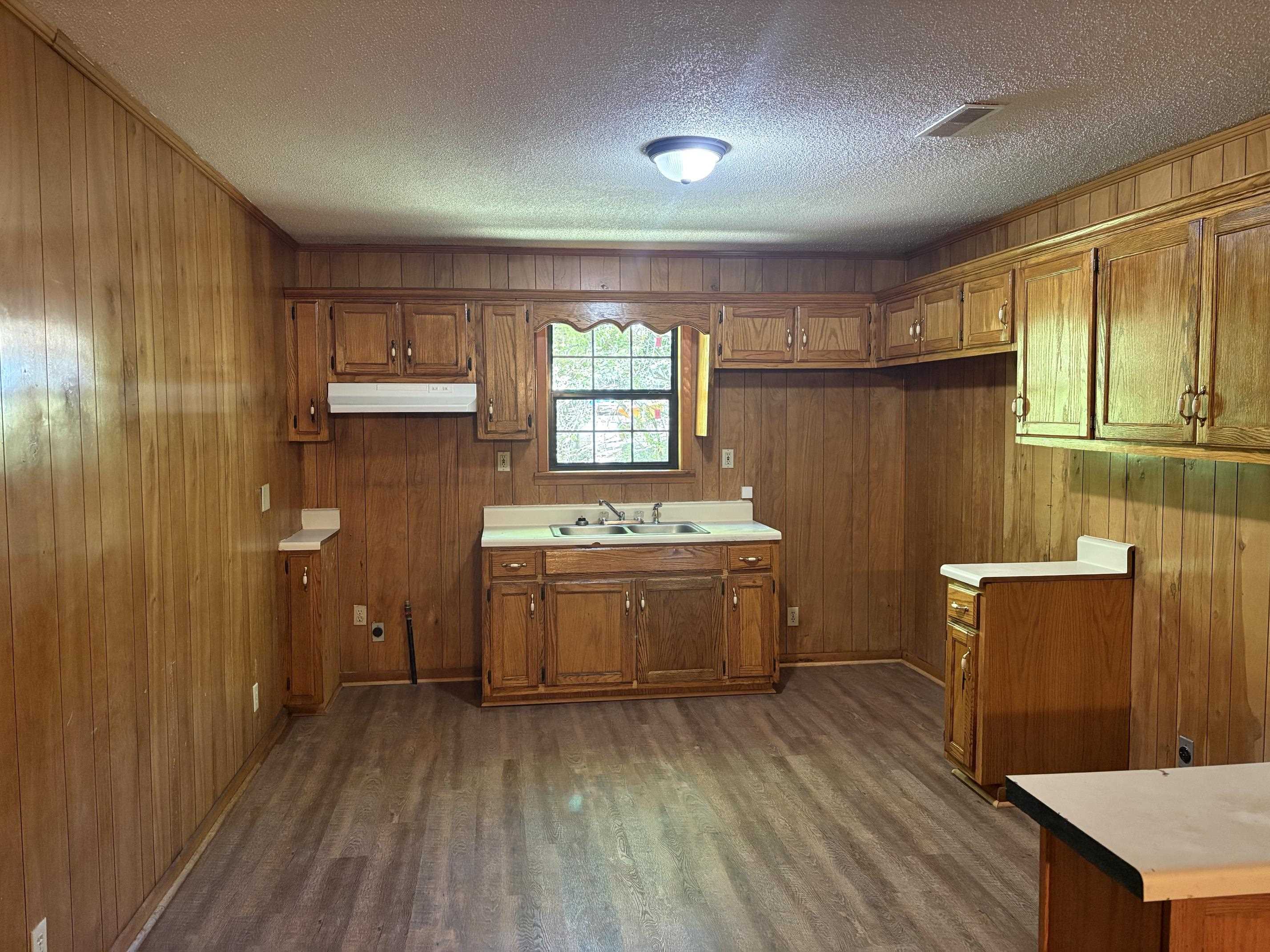 146 Walker Street Ripley, TN 38063 - Photo 4 of 14 a view of a kitchen with wooden floor and electronic appliances