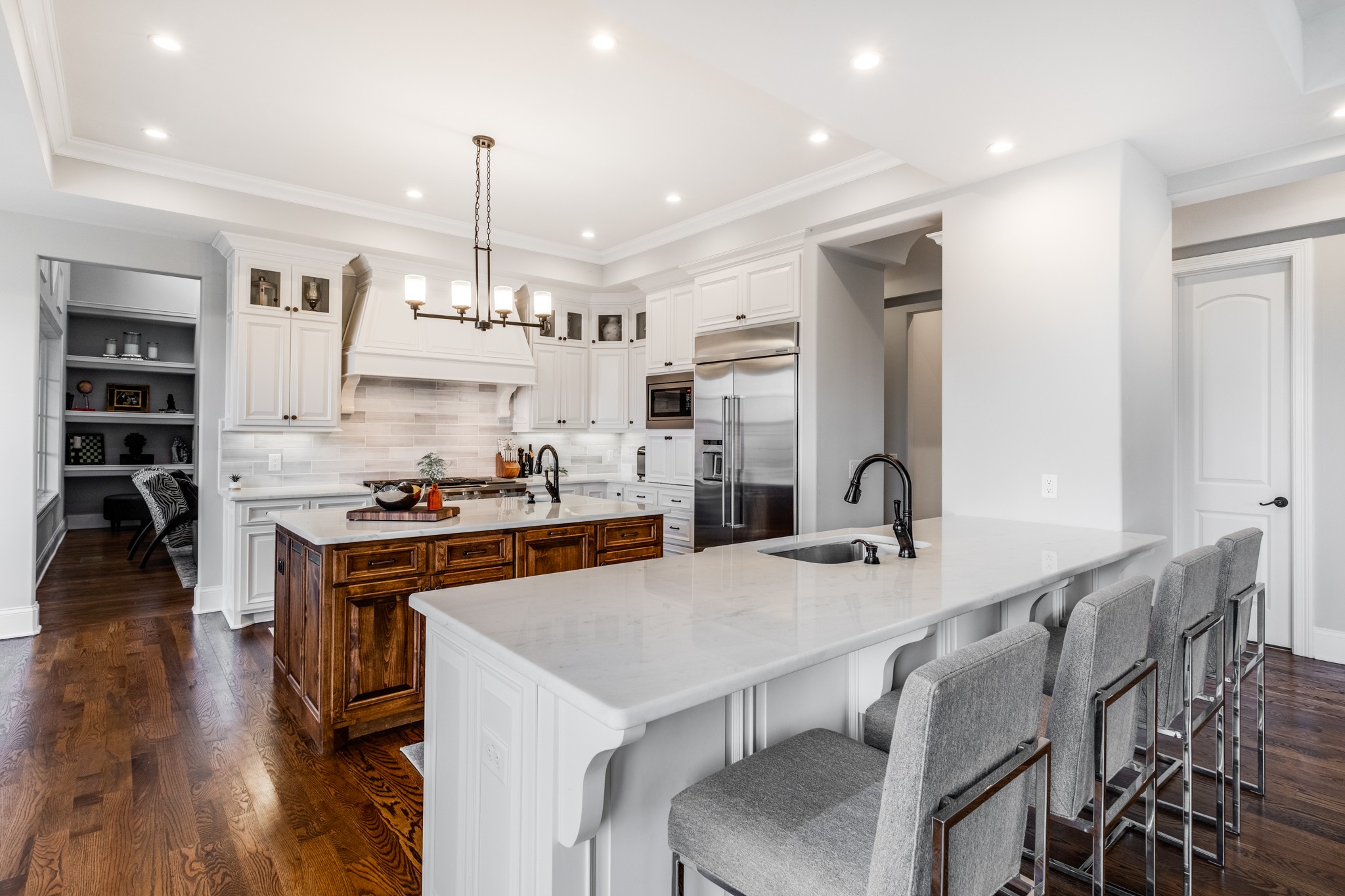 514 Legends Ridge Court Franklin, TN 37069 - Photo 18 of 57 a kitchen with stainless steel appliances a dining table chairs stove refrigerator and cabinets