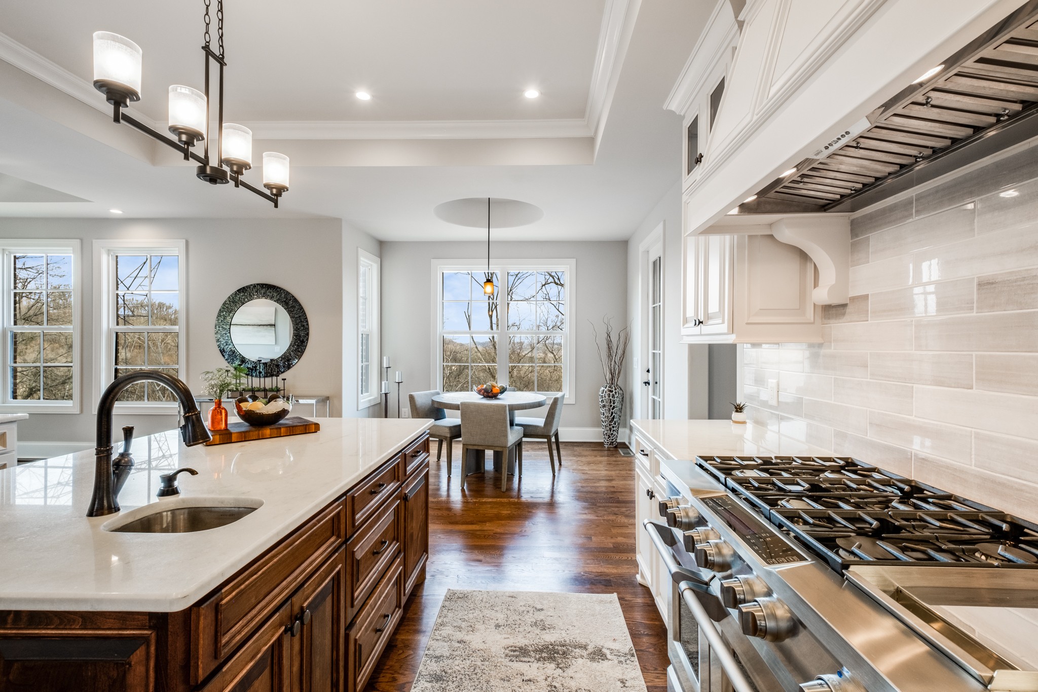 514 Legends Ridge Court Franklin, TN 37069 - Photo 20 of 57 a kitchen with stainless steel appliances granite countertop a sink a stove and a dining table with wooden floor